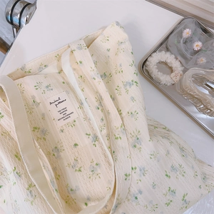 Detail of floral lace cotton tote bag showing the textured surface and handle