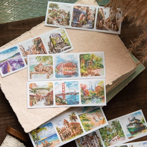 Artistic landscape washi stickers with travel scenes and cats on a vintage notebook