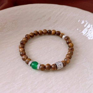 Detailed view of agarwood beaded bracelet with green agate and cubic zirconia accents