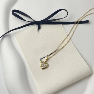 Close-up of heart pendant necklace in 18K gold plating with full zircon stones