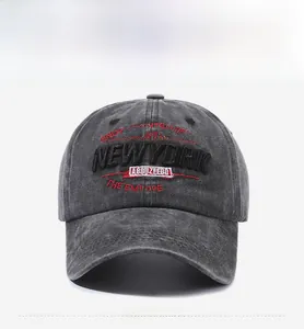 Macro detail of dark grey washed cotton baseball cap with New York vintage embroidery