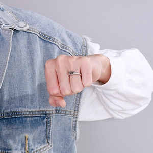 Close-up of vintage silver signet ring with dark oval gemstone on a male model