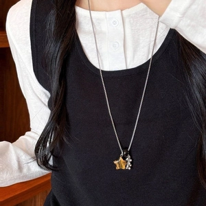 Vintage stainless steel necklace featuring a tiger eye star pendant and silver ball tassels
