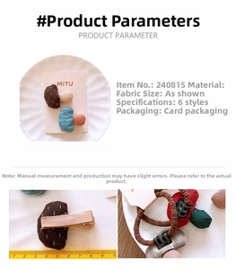 Detail of mushroom-shaped fabric hair clips and ties with grid patterns and measurements