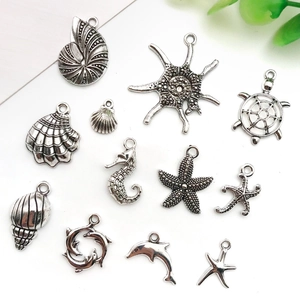 Detailed flat lay of antique silver sea creature pendants including seahorse and turtle