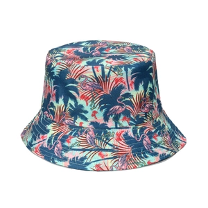 Detail of tropical bucket hat featuring pink flamingo and palm leaf print pattern