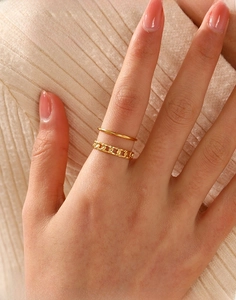 Detail of double-layer gold stainless steel chain ring set worn on finger