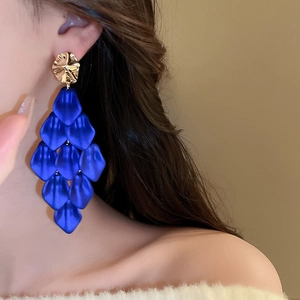 Detail of royal blue acrylic petal tassel earrings on model showing layered flower design