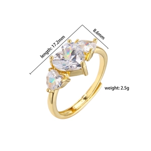 Macro shot of gold brass ring featuring three heart-shaped white zircon stones with dimensions