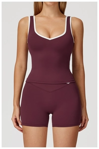 Close-up of a burgundy workout set featuring contrast white trim and high-waisted gym shorts