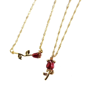 Vintage 18k gold plated brass necklace with 3D red enamel rose pendants on white background