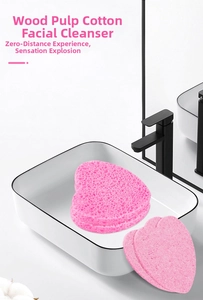 Detailed stack of heart-shaped pink cellulose sponges on a modern bathroom sink vanity