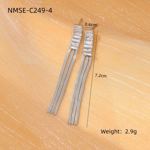 Detail showing dimensions of silver tassel earrings with cubic zirconia on gold fabric