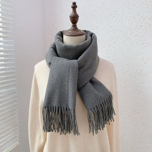 Close-up of soft grey cashmere feel scarf with fringe tassels on mannequin neck