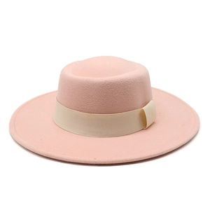 Detail of light pink wool felt boater hat featuring a beige grosgrain ribbon bow