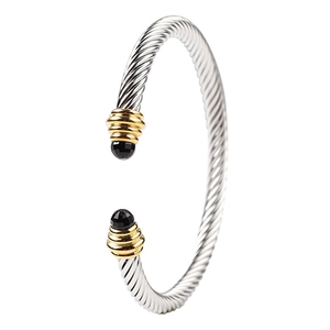 Silver twisted cable stainless steel bracelet with gold accents and black gemstone inlays