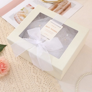 Elegant beige square gift box with transparent window and white ribbon bow decoration