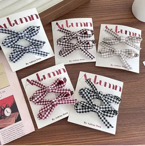 Set of plaid bow hair clips in multiple colors displayed on vintage cards