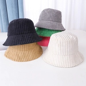 Detailed pile of assorted corduroy bucket hats in black, grey, pink, and khaki colors