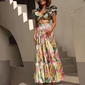Detail of vibrant bohemian floral print crop top with ruffles and metal ring decoration
