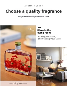 Close-up of glass reed diffuser with red dried flowers and gold cap in home setting
