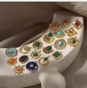 Collection of retro 18k gold-plated pendants with natural gemstones on a ceramic stand