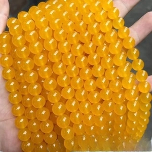 Macro detail of polished yellow natural stone beads with smooth finish and high gloss