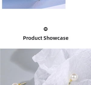 Detail view of pearl earrings with gold plating and sparkling zircon accents on silk