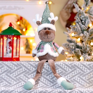 Detail of Christmas reindeer plush with plaid outfit, green hat and golden bell accent