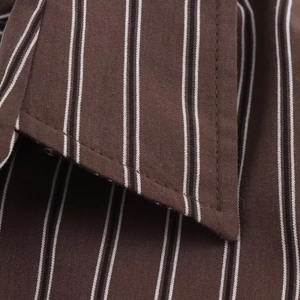Close-up detail of the brown striped shirt collar showing high-quality fabric stitching