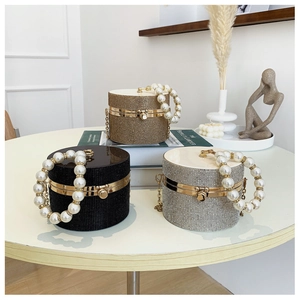 Chic rhinestone-encrusted cylindrical evening clutch with pearl handle and metal clasp