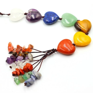 Macro detail of natural seven-color crystal tree of life with heart stones and brown tassels