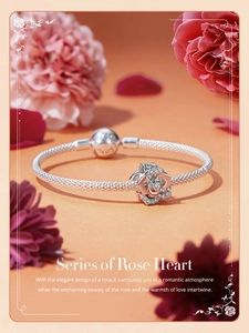 Detail of rose gold flower charm on silver braided bracelet with sparkling rhinestones