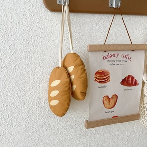 Detail of creative baguette-shaped foldable shopping bag charms with hanging ropes