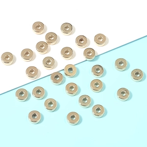 Macro detail of flat round golden CCB spacer beads for DIY jewelry making and crafts
