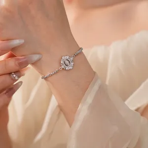 Elegant silver chain bracelet with a sparkling zircon religious portrait medallion on wrist