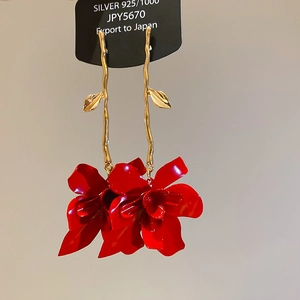 Detailed macro view of red orchid flower drop earrings with 925 silver needles