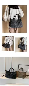 Macro shot of matte faux leather textures and side pocket details on a Boston tote bag
