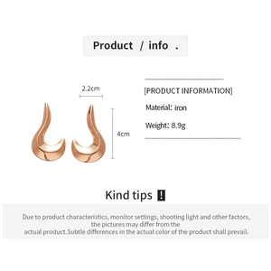 Detailed view of crescent-shaped rose gold iron earrings with 4cm height dimensions