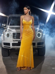 Luxurious yellow velvet evening dress with sequins and corset bodice in a model photoshoot