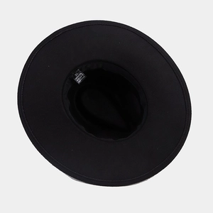 Detail view of black wide brim fedora hat interior with size 57 label and sweatband