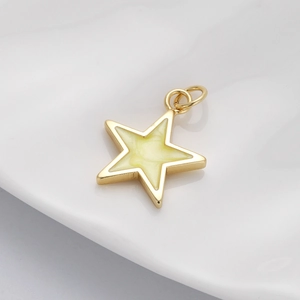 Close-up of a gold star-shaped pendant with sparkly cream enamel and a connecting ring