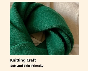 Close-up of soft emerald green knitted texture showing fine wool fibers and weave