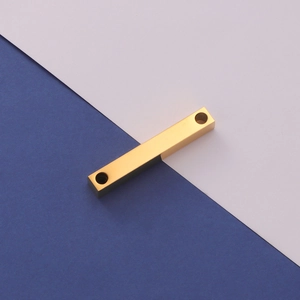 Detail of a dual-hole golden 3D rectangular bar pendant with a polished mirror finish