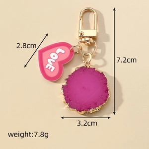 Detail showing dimensions of heart keychain with LOVE text and purple resin stone charm