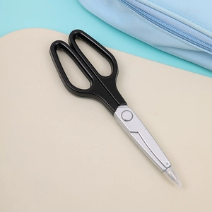 Detail of scissor-shaped ballpoint pen in black and silver creative stationery tool design