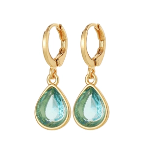 Macro detail of teardrop blue stone earrings with polished gold base setting