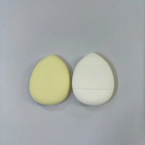 Top view of yellow and white fiber powder puffs on a clean professional gray background