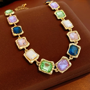 Macro shot of colorful rectangular crystals in vintage gold hammered metal setting