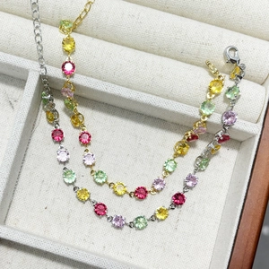 Macro detail of multi-color zircon bracelets in gold and silver finish with lobster clasp